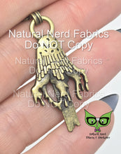 Load image into Gallery viewer, Bronze metal zipper pull shaped like a dripping inky cap mushroom. The pull has a detailed design with a textured surface.