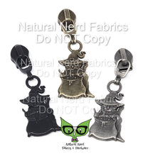 Load image into Gallery viewer, Three zipper pulls with a black, antique silver, and bronze finish. Each pull features a cat with an eyepatch wearing a robe and witch's hat stirring a cauldron.