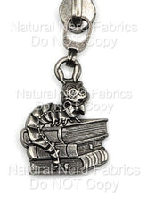 Load image into Gallery viewer, Silver-toned zipper pull featuring a detailed caterpillar character perched atop a stack of books. The caterpillar has large eyes and a bow tie.