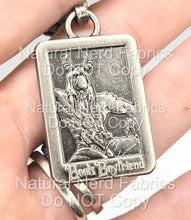 Load image into Gallery viewer, A rectangular, silver-colored zipper pull with a detailed relief of a horned man. The pendant has the words "Book Boyfriend" in a stylized font at the bottom.