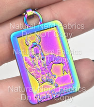 Load image into Gallery viewer, A rectangular, rainbow-colored zipper pull with a detailed relief of a horned man. The pendant has the words "Book Boyfriend" in a stylized font at the bottom.
