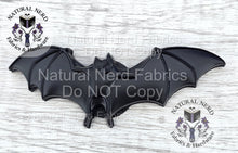 Load image into Gallery viewer, A mate black-colored metal bat-shaped snap embellishment. The bat has outstretched wings and detailed features. This item is suitable for crafting and sewing projects.