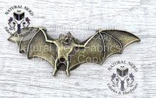Load image into Gallery viewer, A bronze-colored metal bat-shaped snap embellishment. The bat has outstretched wings and detailed features. This item is suitable for crafting and sewing projects.