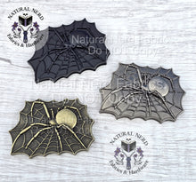 Load image into Gallery viewer, Three metal spider web magnetic snaps. The design is a web with a spider in the center. The spider and web are detailed with intricate lines. The design is rectangular and has a vintage or antique appearance. Colors shown include antique bronze, matte black, and antique nickel.