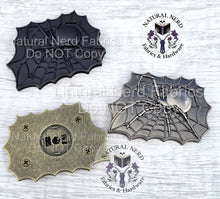 Load image into Gallery viewer, Three metal spider web magnetic snaps. The design is a web with a spider in the center. The spider and web are detailed with intricate lines. The design is rectangular and has a vintage or antique appearance. Colors shown include antique bronze, matte black, and antique nickel. The bronze snap is flipped over to see the back which features four screws and a circular area to install the snap parts.