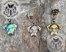 Load image into Gallery viewer, Dog-shaped zipper pulls in 3 colors on a textured surface with 'Natural Nerd Fabrics & Hardware' branding. Colors shown are matte rainbow, antique nickel, and bronze.