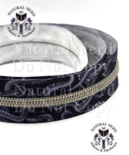 Load image into Gallery viewer, Black and white zipper tape with silver teeth and a tentacle design.