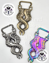 Load image into Gallery viewer, Three octopus-themed purse strap anchors with a twisting tentacle design on a white background, showing antique bronze, silver, and iridescent holographic finishes. Watermarks for 'Natural Nerd Fabrics & Hardware' are visible.