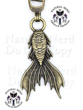 Load image into Gallery viewer, A bronze metal mermaid tail zipper pull next, with a 'Natural Nerd Fabrics & Hardware' logo watermark on the image.