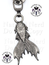 Load image into Gallery viewer, An antique silver metal mermaid tail zipper pull next, with a 'Natural Nerd Fabrics & Hardware' logo watermark on the image.