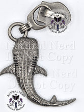Load image into Gallery viewer, An antiqued silver metal whale shark zipper pull with textured detailing. The image features 'Natural Nerd Fabrics & Hardware' watermarks on a white background.