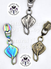 Load image into Gallery viewer, Three common stingray zipper pulls shown in three finishes: antique nickel, bronze, and matte rainbow