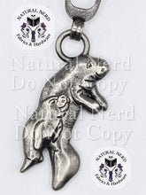 Load image into Gallery viewer, close up of an antique nickel zipper pull with a momma and baby manatee design
