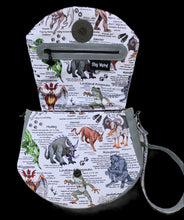 Load image into Gallery viewer, The interior of a handbag made with Cryptid fabric. The bag is trimmer with grey vinyl and has a black mothman zipper pull and a stay weird tag.