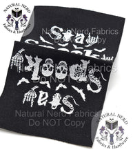 Load image into Gallery viewer, A black fabric label is shown laying open face up with white text and skeleton-themed graphics. The text includes "Stay Spooky". The label feature skulls, bats, and skeleton hands, perfect for Halloween or gothic-themed projects.
