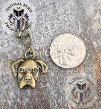Load image into Gallery viewer, Bronze dog head zipper pull on a textured surface with 'Natural Nerd' branding. The dog breed is a boxer. Shown nextto a US quarter coin for size comparison.
