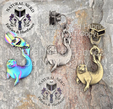Load image into Gallery viewer, A collection of three detailed zipper pulls designed to look like harbor seals. Three finishes are on display: matte rainbow, antique silver, and bronze.
