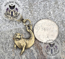 Load image into Gallery viewer, A bronze detailed zipper pull designed to look like a harbor seal. The pull is shown next to a quarter for scale.
