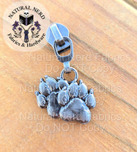 Load image into Gallery viewer, An antique nickel detailed zipper pull designed to look like a pair of canine paw prints. 
