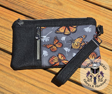 Load image into Gallery viewer, Wristlet with butterfly pattern on a wooden surface
