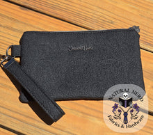 Load image into Gallery viewer, Black textured pouch with a strap on a wooden surface, featuring 'Natural Nerd Fabrics &amp; Hardware' branding.
