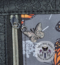 Load image into Gallery viewer, antique silver Butterfly zipper pull on a fabric background
