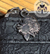 Load image into Gallery viewer, Black textured bag with a silver sunflower zipper pull
