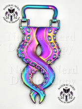 Load image into Gallery viewer, A matte rainbow octopus tentacle strap anchor with detailed suckers, shown on a white background with 'Natural Nerd Fabrics &amp; Hardware' watermarks.
