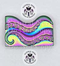 Load image into Gallery viewer, A rainbow metal octopus strap end with detailed suction cups, shown on a white background with 'Natural Nerd Fabrics &amp; Hardware' watermarks.
