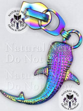 Load image into Gallery viewer, A matte rainbow metal whale shark zipper pull with textured detailing. The image features 'Natural Nerd Fabrics &amp; Hardware' watermarks on a white background.

