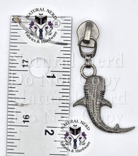 Load image into Gallery viewer, A silver-toned whale shark zipper pull with textured detailing, shown next to a metal ruler for scale on a white background with a 'Natural Nerd Fabrics &amp; Hardware' watermark.
