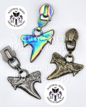 Load image into Gallery viewer, Three shark tooth shaped zipper pulls shown in three finishes: antique nickel, matte rainbow, and antique bronze.
