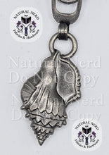 Load image into Gallery viewer, An antique silver seashell-shaped metal zipper pull, shown on a white background with 'Natural Nerd Fabrics &amp; Hardware' watermarks.

