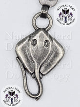 Load image into Gallery viewer, A silver-toned metal zipper pull shaped like a stingray, featuring detailed eye and mouth carvings, shown against a white background with 'Natural Nerd Fabrics &amp; Hardware' watermarks.
