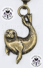 Load image into Gallery viewer, An antique bronze-finished metal seal zipper pull, shown against a white background with watermarks and brand logos for 'Natural Nerd Fabrics &amp; Hardware'.
