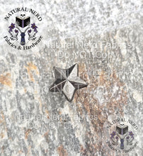Load image into Gallery viewer, Antique Nickel star-shaped Chicago screw on a textured surface with 'Natural Nerd' branding. 
